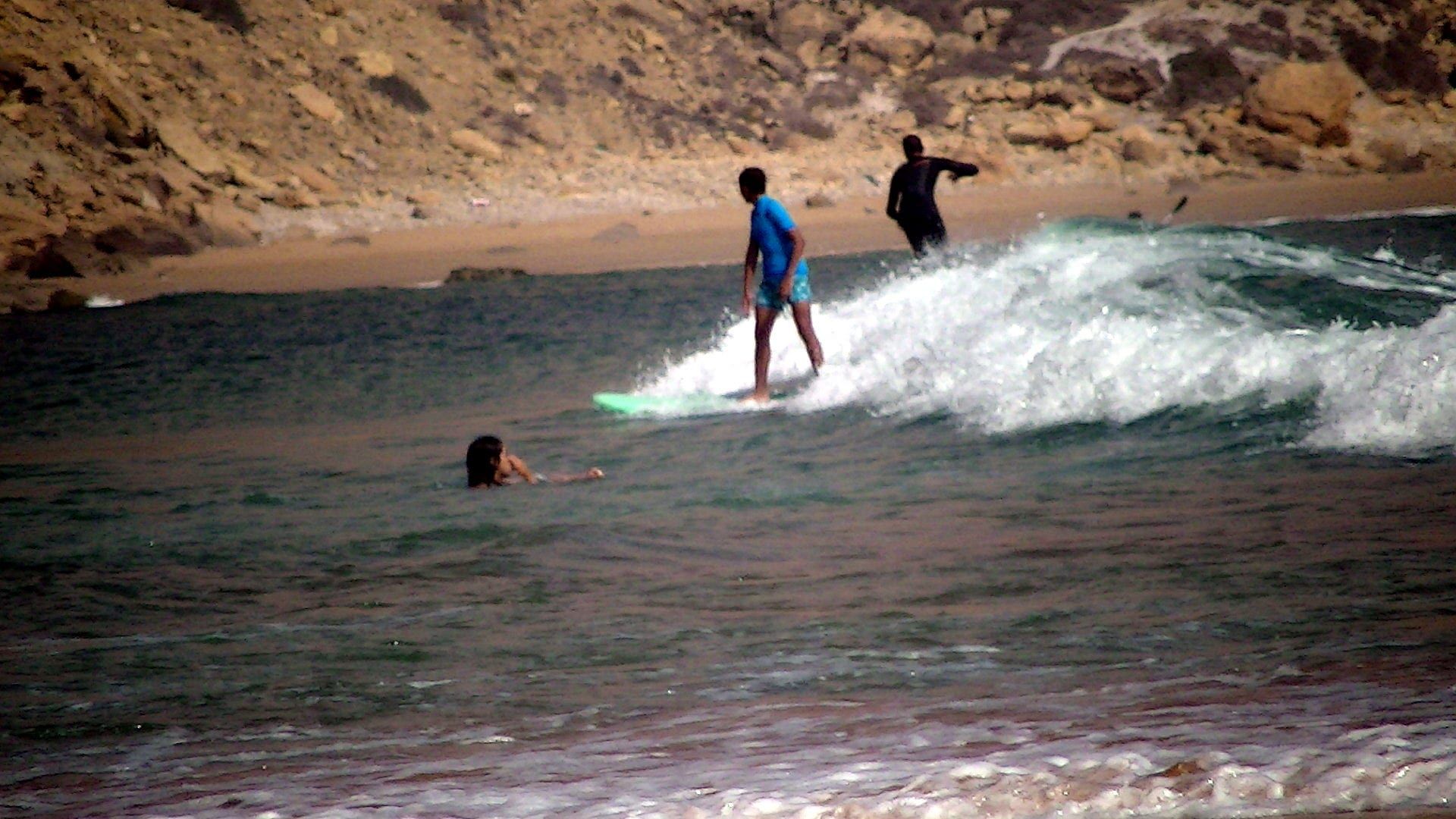 A surfer riding a wave in the bay of Imsouane