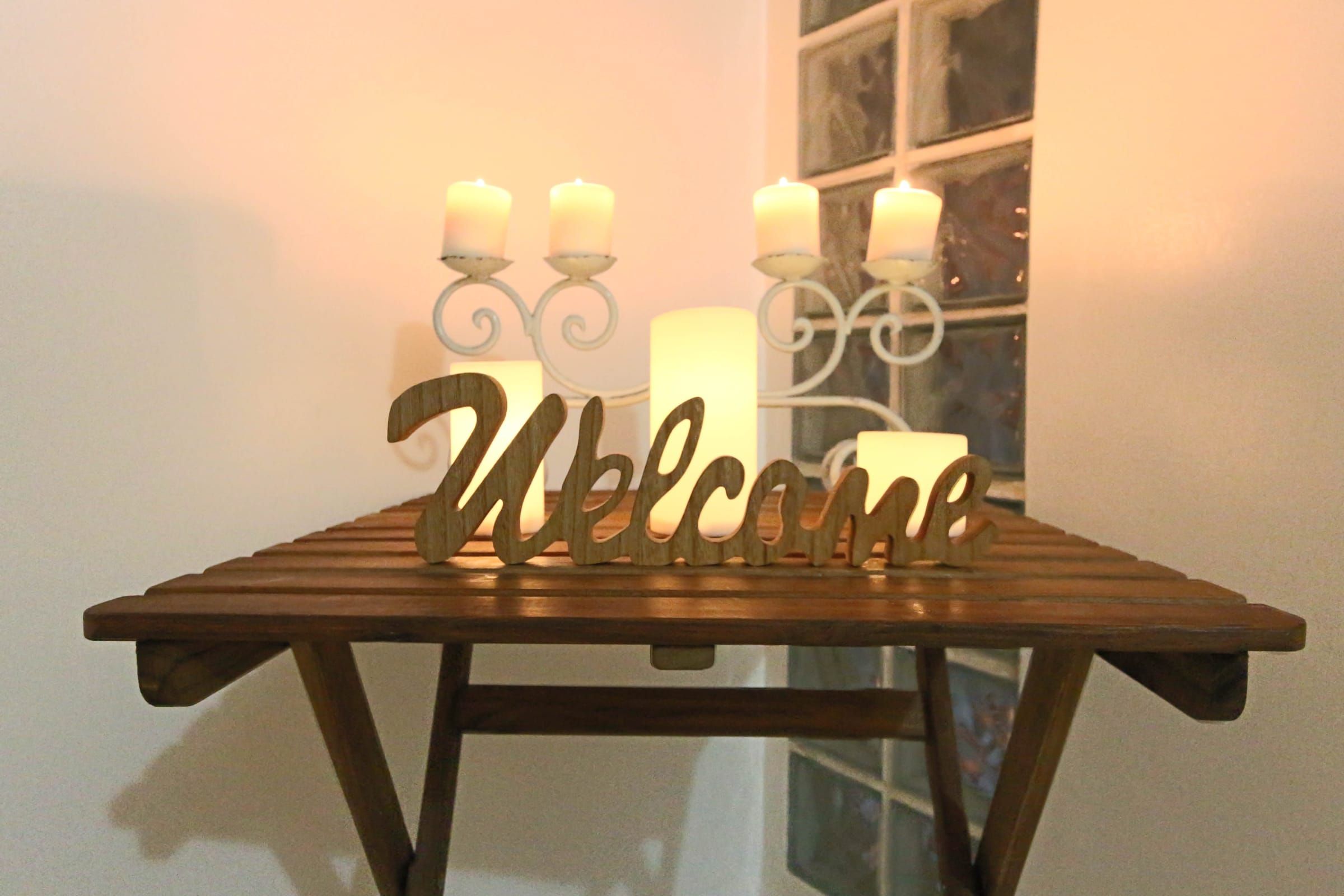 A “Welcome” sign on a wooden table