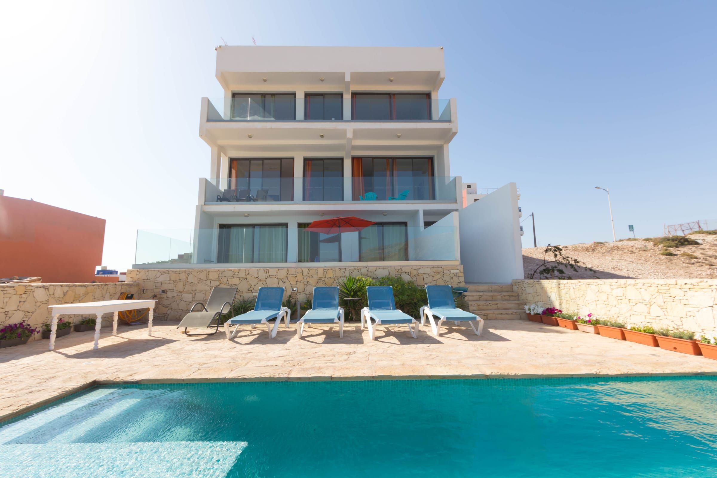 Wind House seen from the pool, with its terraces and sun loungers
