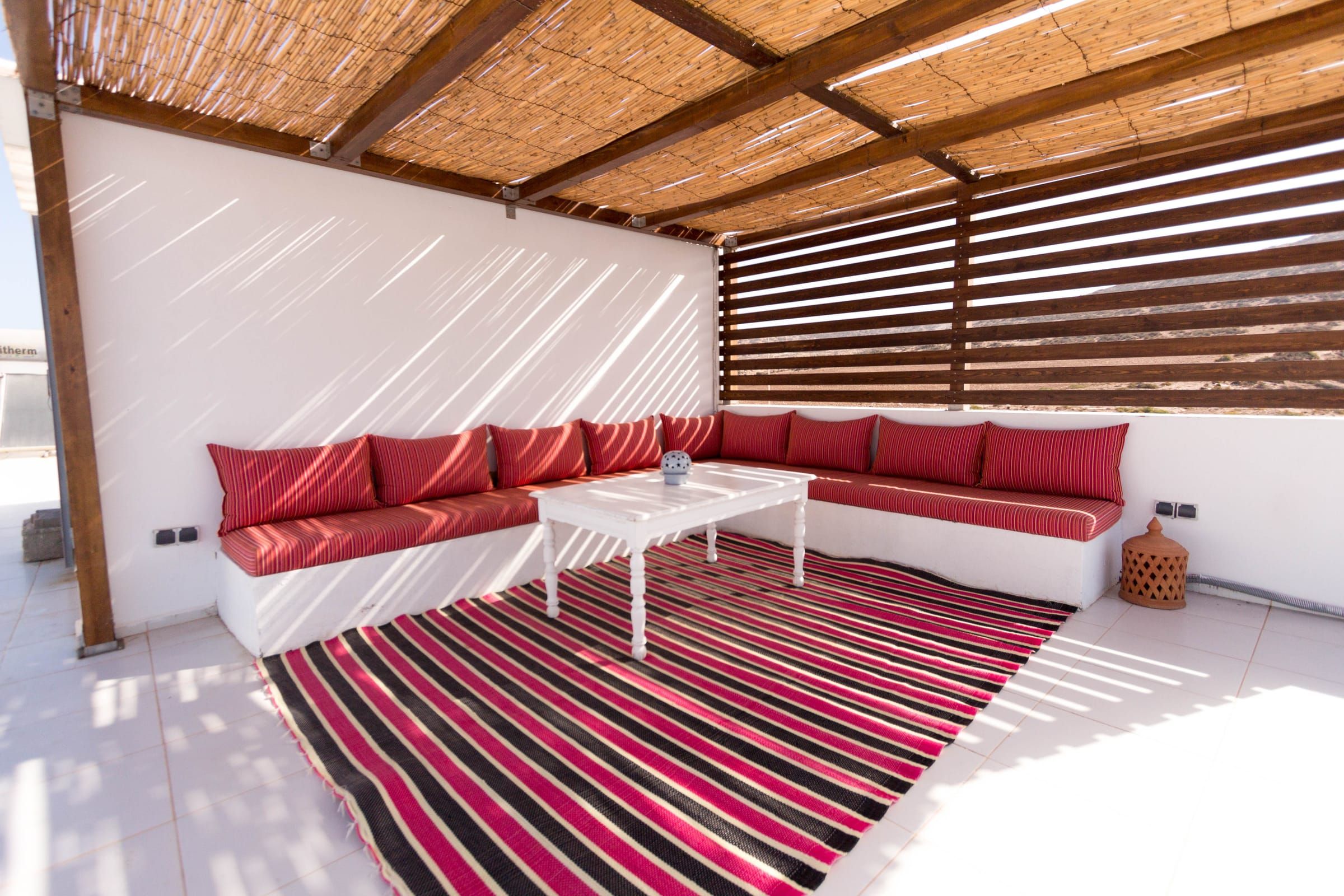 The rooftop lounge under its reed pergola