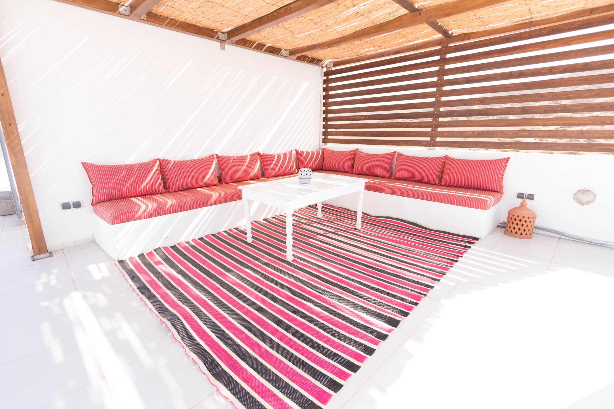 The rooftop lounge under the reed pergola