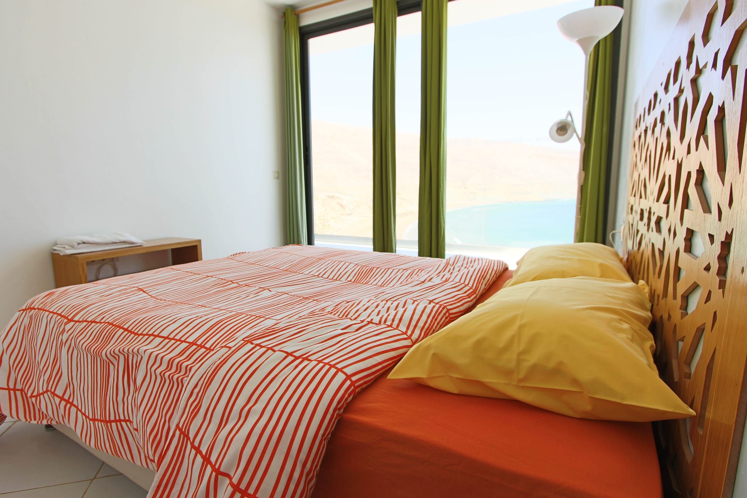 Double bed with a carved headboard
